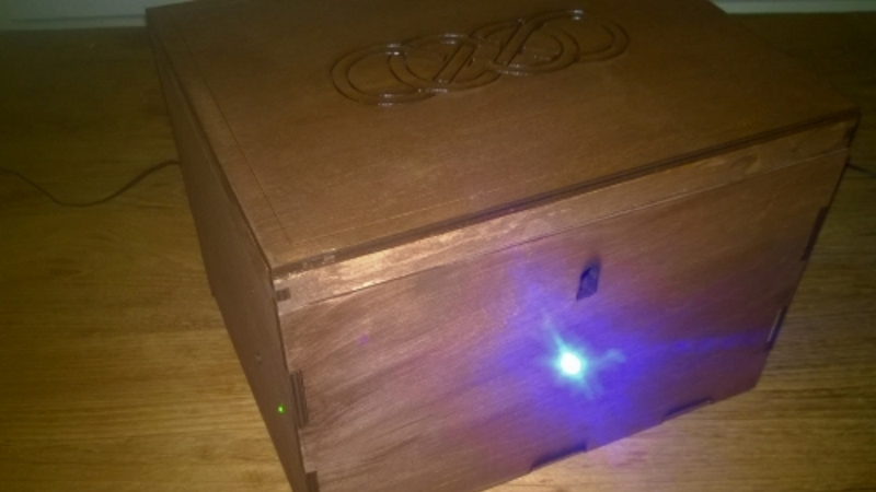 Pandora box fully assembled and stained — a compact wooden box with a webcam lens and wooden peg buttons