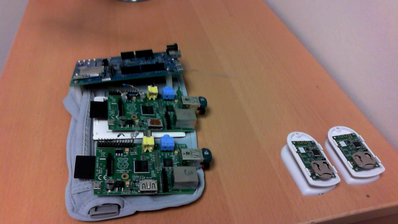 IoT hardware components: Intel Edison, two Raspberry Pis, and Bluetooth Beacons laid out on a table