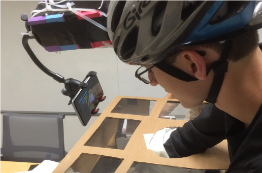 Medium-fidelity helmet prototype: a bike helmet with a phone holder mounting an iPhone in front of the visor