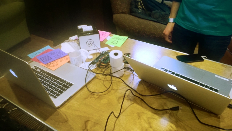 Demo table set up for judges with PixyCam, printer, and paper app cards on display