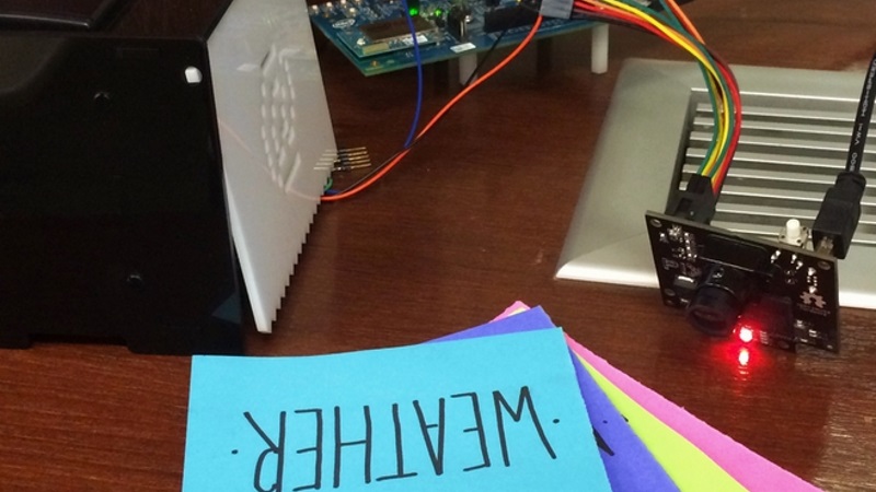 Mago system on a table — thermal printer, PixyCam, and colored paper cards